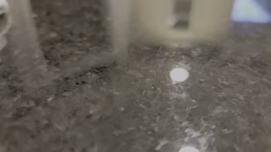 Five minutes of handheld video, mostly blurred: a porch, a doorway, a garage floor, a kitchen counter, with two people talking loudly over each other the whole time.